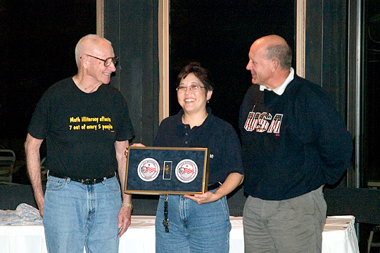 Glenn Purdy (left) and Bob Price (right) presenting the 2004 Glenn Purdy Meritorious Service Award to Emi Vishoot